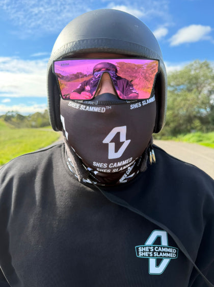 Person wearing a helmet and face mask with visible branding outdoors
